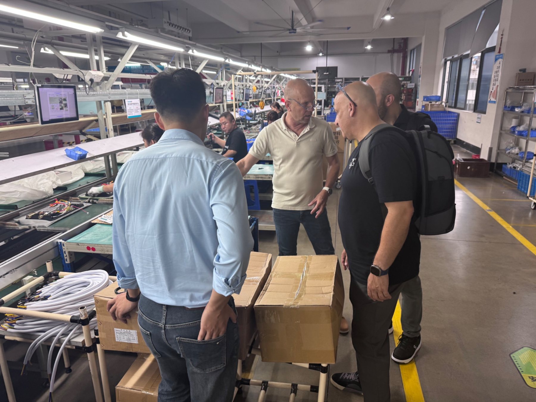GUDIS team and partners visiting a production line in China